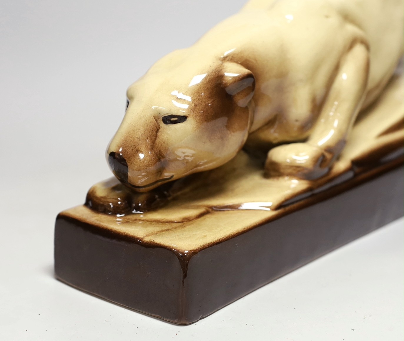 An Art Deco French pottery figure of a stalking panther, 53cm long